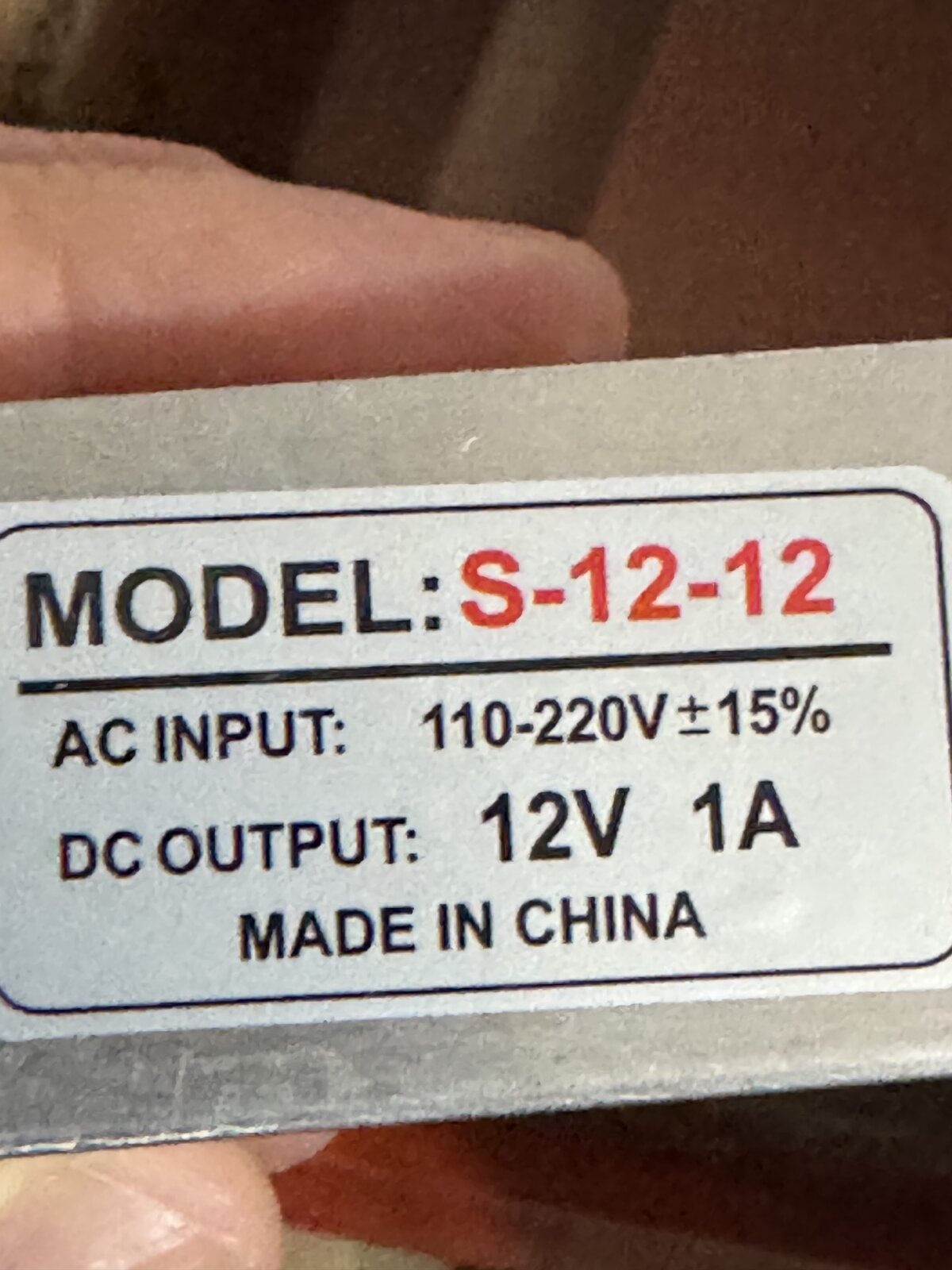 Rating label on the AC to 12V 1A power supply, model S-12-12, 110 to 220V AC input and 12V 1A DC output