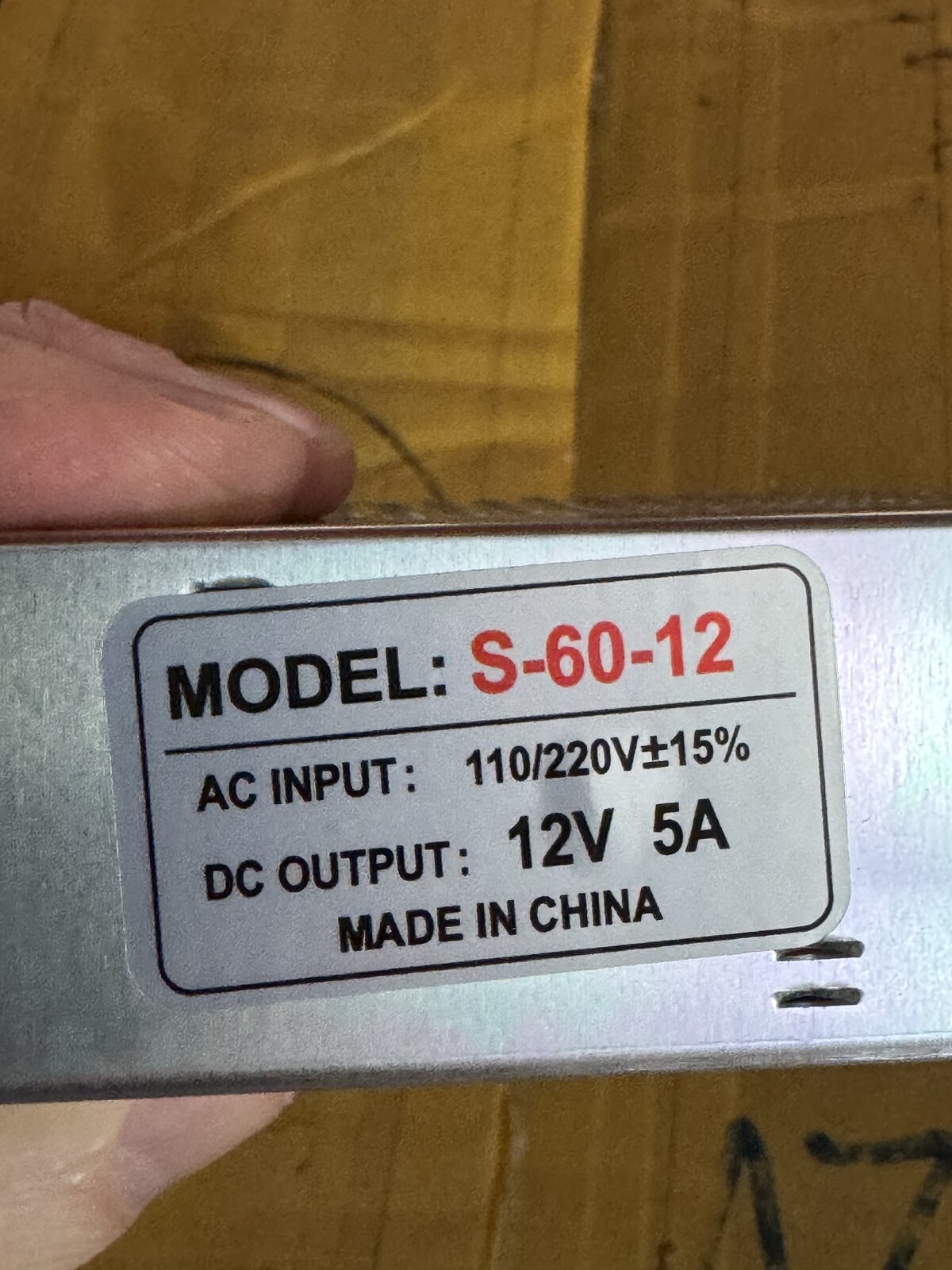 Rating label on the AC to 12V 5A power supply, model S-60-12, 110 to 220V AC input and 12V 5A DC output