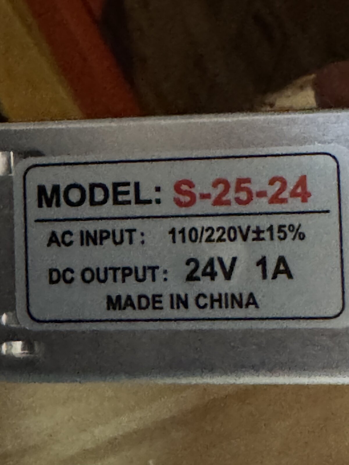 Rating label on the AC to 24V 1A power supply, model S-25-24, 110 to 220V AC input and 24V 1A DC output