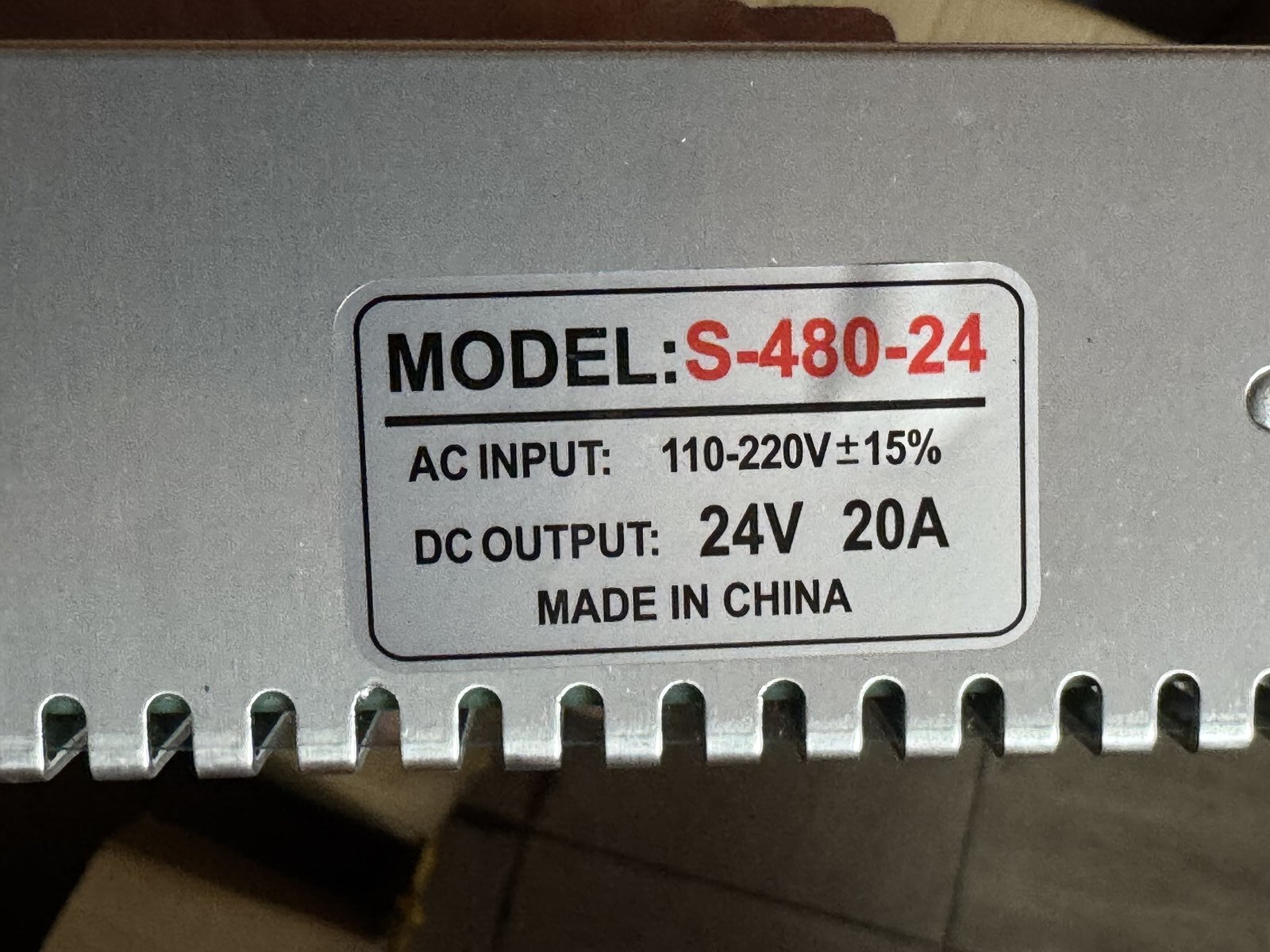 Rating label printed along the vented case of the AC to 24V 20A power supply, model S-480-24, 110 to 220V AC input and 24V 20A DC output